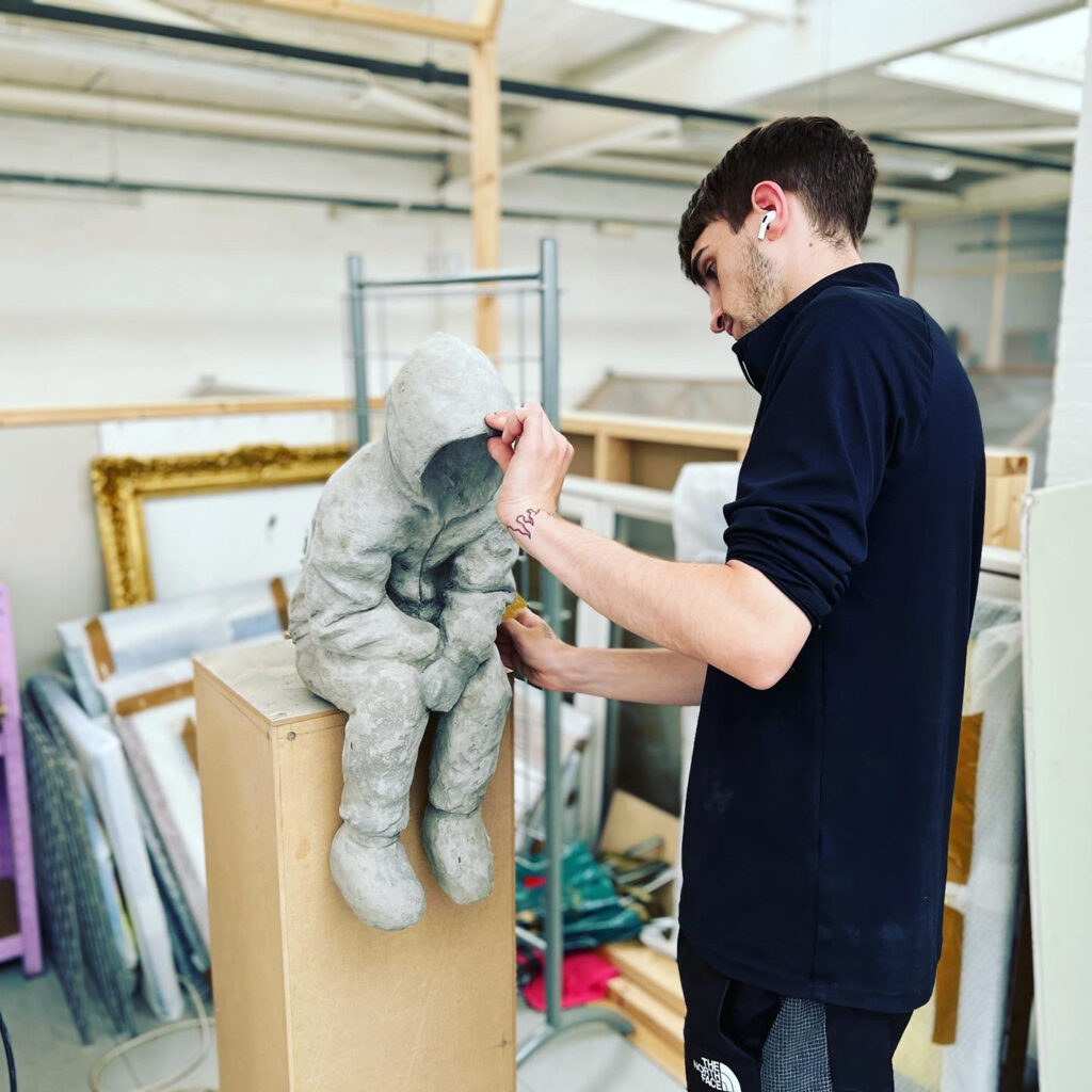 Young person making sculpture